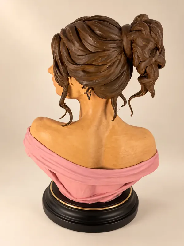 Hand-painted bust of a woman with an updo, seen from the back